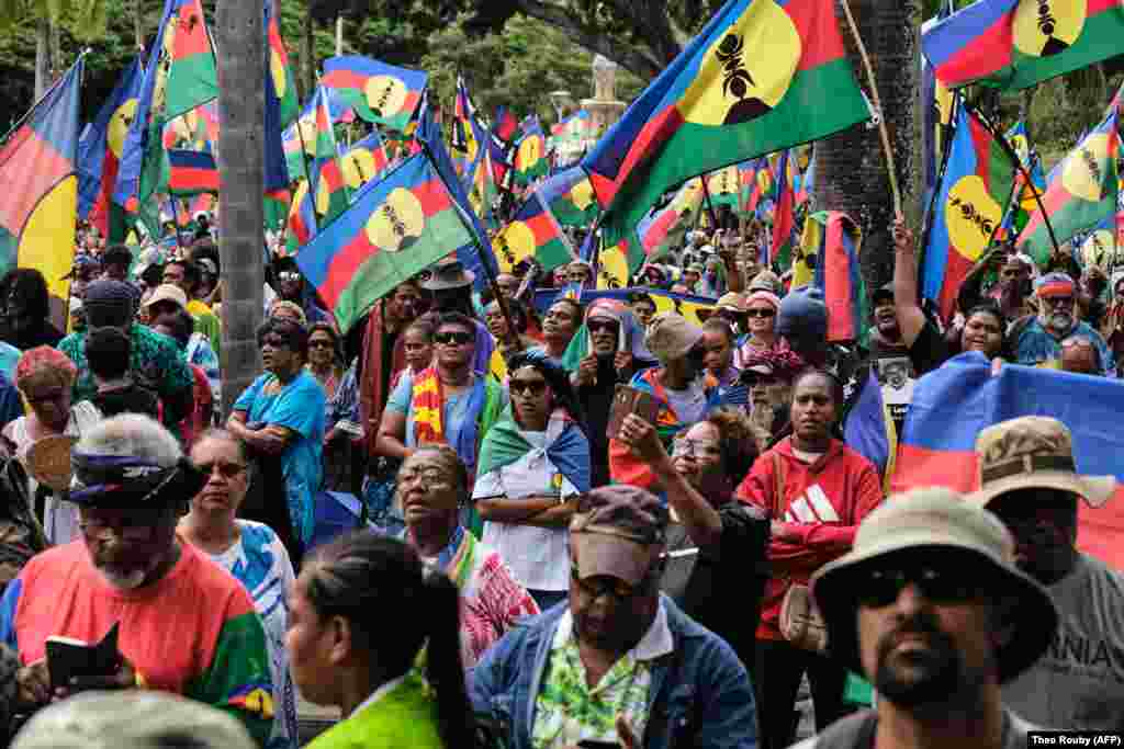 Protesters wave Kanak flags during a demonstration against the voting law on April 13.&nbsp; As protests were spreading in New Caledonia, the Baku group posted a call for the &quot;mobilization&quot; of Kanaks on May 8 to protest the &quot;recolonization&quot; of New Caledonia. Since May 13, at least six people have died in the unrest.
