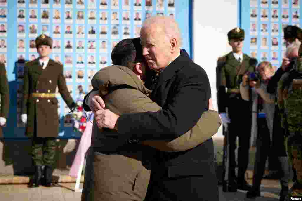 Biden embraces Zelenskiy as they visit the Wall of Remembrance in Kyiv to pay tribute to Ukrainian soldiers killed amid Russia's attack on Ukraine.