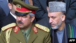 Hamid Karzai (right) with then Deputy Defense Minister General Abdul Rashid Dostum in March 2002.
