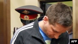 Russian Police Major Denis Yevsyukov being led into court in April in connection with his shooting rampage.