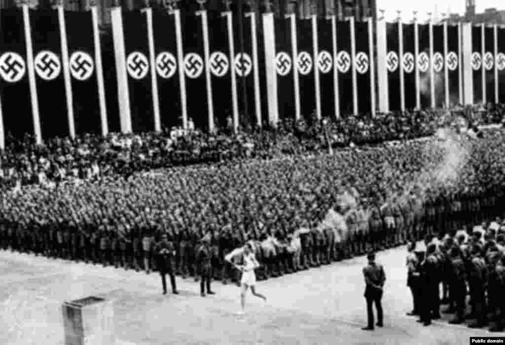 Torchbearer Fritz Schilgen carries the Olympic flame to open the Berlin Games in 1936, after a trip of 3,422 kilometers.