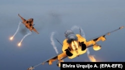 Two Spanish F-18 fighters release flares as they take part in NATO exercises. (file photo)