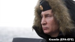 Russian President Vladimir Putin attends joint drills of the Northern and Black Sea fleets on board the Russian guided-missile cruiser Marshal Ustinov in the Black Sea, off the coast of Crimea, on January 9.