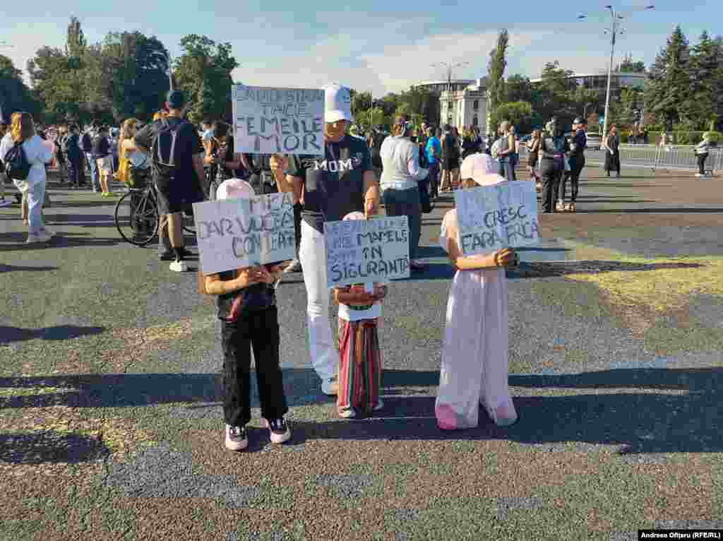Children hold signs at the protest.The shocking May 31 murder of Marcu is the 25th case of a woman being murdered in Romania in just the past five months. Marcu's alleged killer shot himself soon after the murder.