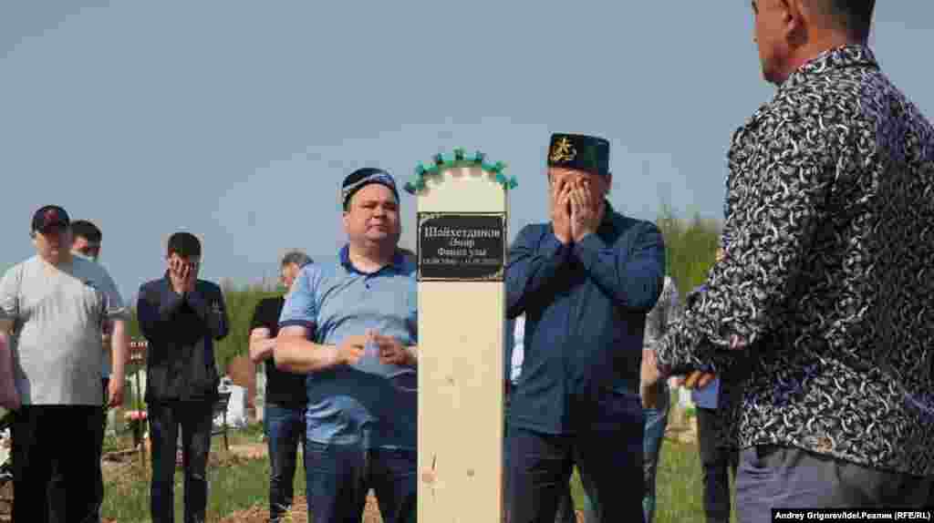 People attend the funeral of Amir Shaikhutdinov, 14, on May 12. Amir's classmates Ilzia Nagimullina and Damir Gaynutdinov were also buried.