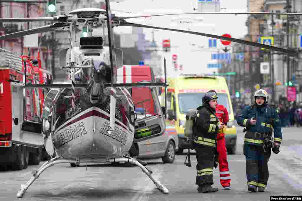 Emergency vehicles and a helicopter are seen outside the St. Petersburg Metro&#39;s Tekhnologichesky Institut station.