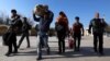 Video Appears To Show Iranian Police Officer Assaulting Afghan Migrants