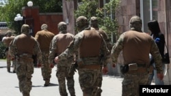 Armenia - Masked law-enforcement officers leave Electric Networks of Armenia (ENA), 8 July, 2025