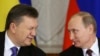 Russia -- Ukrainian President Viktor Yanukovych (L) gives a wink to his Russian counterpart Vladimir Putin during a signing ceremony after a meeting of the Russian-Ukrainian Interstate Commission at the Kremlin in Moscow, December 17, 2013